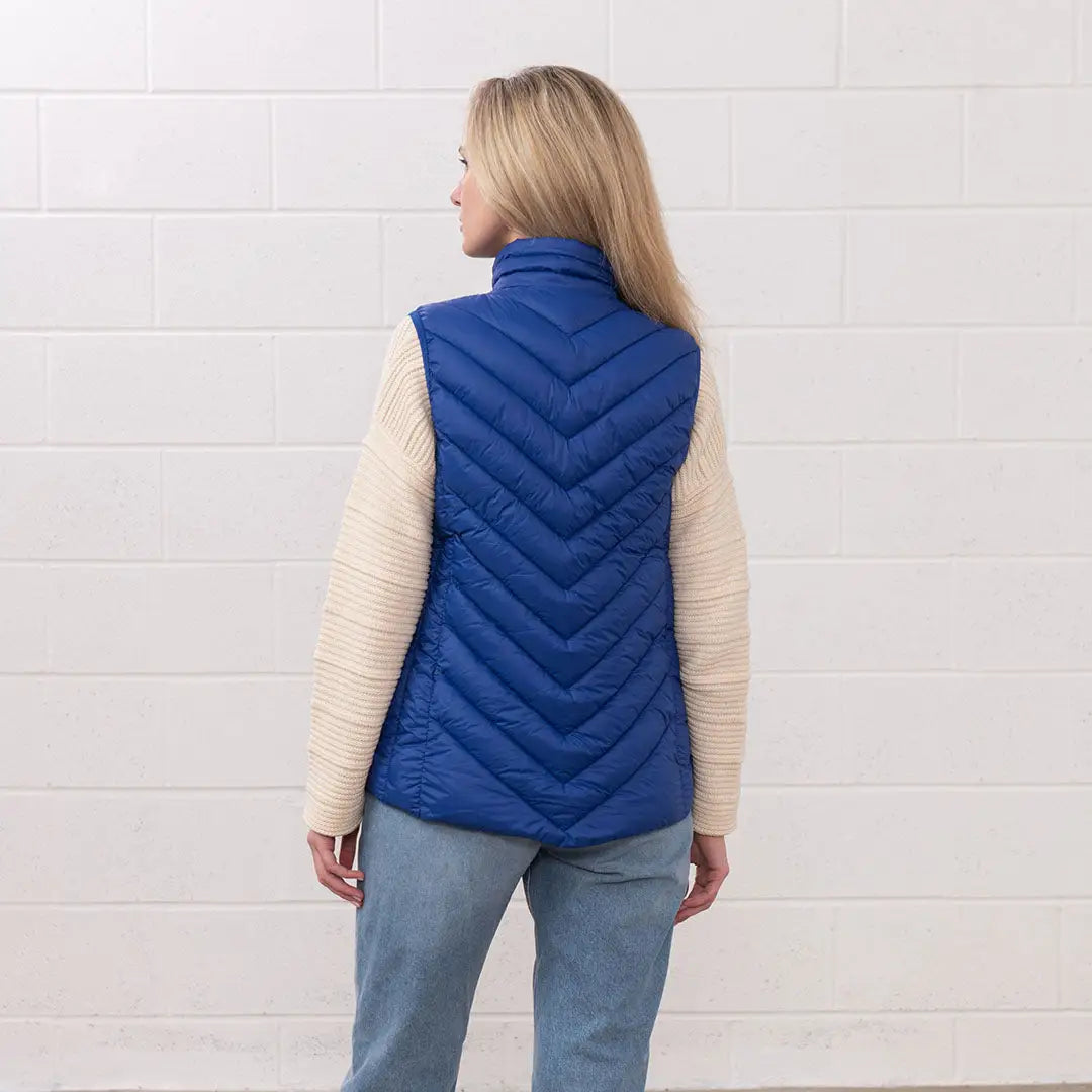 Woman in a blue puffer vest from the Lighthouse Laurel collection, perfect for country clothing
