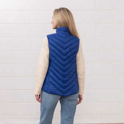Woman in a blue puffer vest from the Lighthouse Laurel collection, perfect for country clothing