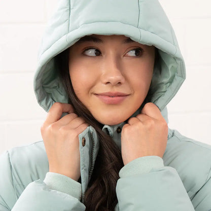 Woman in light green Lighthouse Margot Ladies Coat with hood for stylish winter look