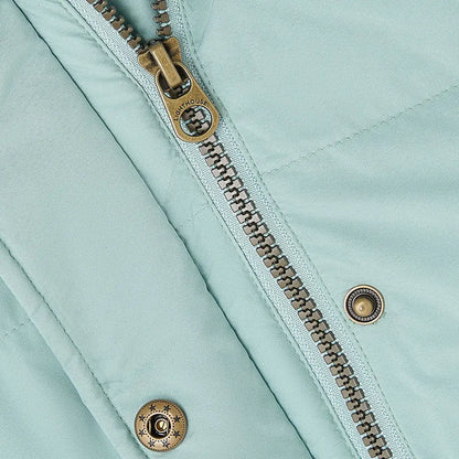 Close-up of Lighthouse Margot Ladies Coat with light blue quilted fabric and bronze details