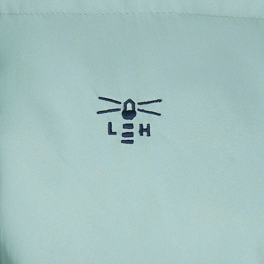 Embroidered lighthouse logo on light blue Lighthouse Margot Ladies Coat fabric