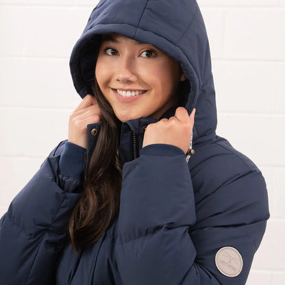 Smiling woman in Lighthouse Margot Ladies Coat navy puffer jacket with hood