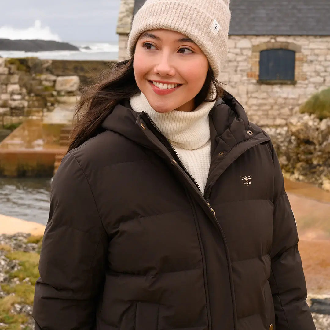 Woman wearing dark brown Lighthouse Savannah Coat with hood and white turtleneck