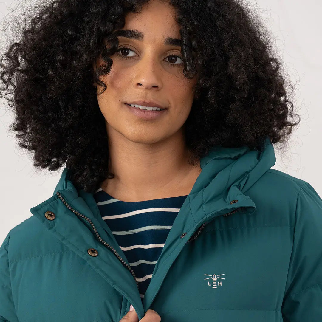 Woman wearing Lighthouse Savannah Coat with dark teal puffer jacket and striped shirt