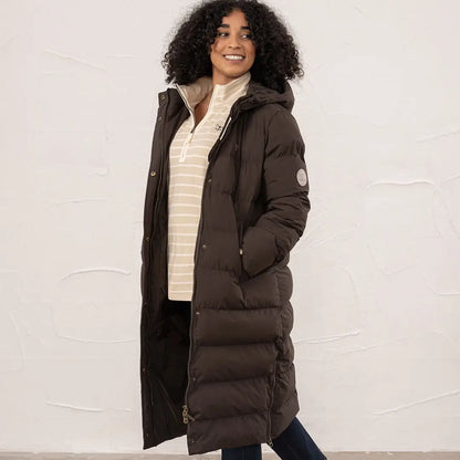 Woman in a dark brown Lighthouse Savannah Coat with striped cream shirt outdoors
