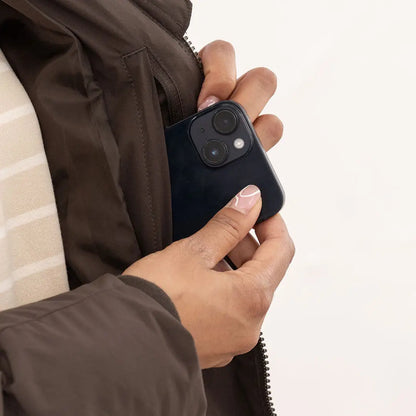 Person putting smartphone in pocket of Lighthouse Savannah Coat for stylish everyday use