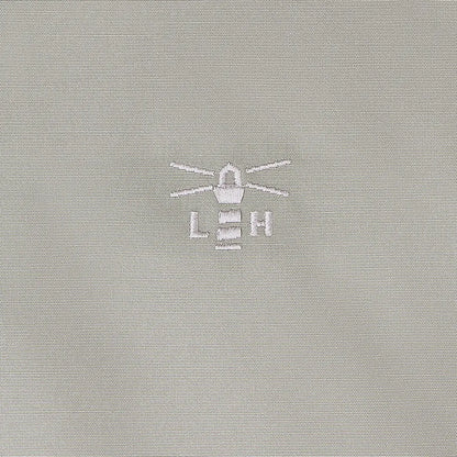 Light gray fabric with embroidered lighthouse logo on Lighthouse Scarlet Ladies Coat for outdoors