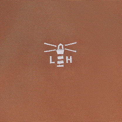 Brown fabric with white lighthouse logo on Lighthouse Scarlet Ladies Coat for country outdoor style
