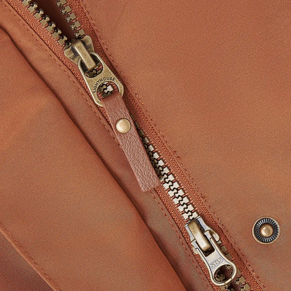 Close-up of Lighthouse Scarlet Ladies Coat zipper with brass pull, perfect for outdoor country clothing and hunting