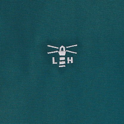 Teal country clothing coat with white embroidered lighthouse logo for outdoors and hunting