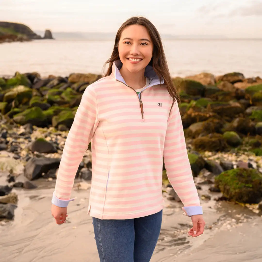 Smiling young woman in Lighthouse Shore cotton jersey sweatshirt, pink and white stripes