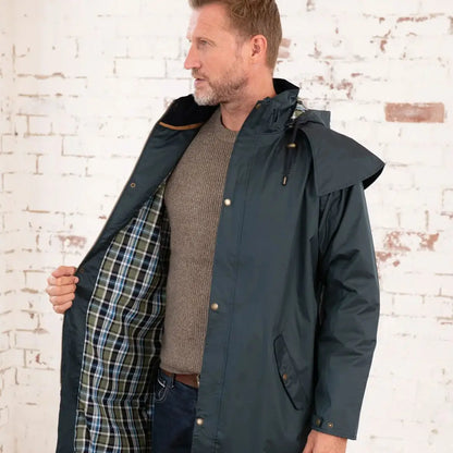 Man wearing a Lighthouse Stockman coat in dark green on a cold winter’s day