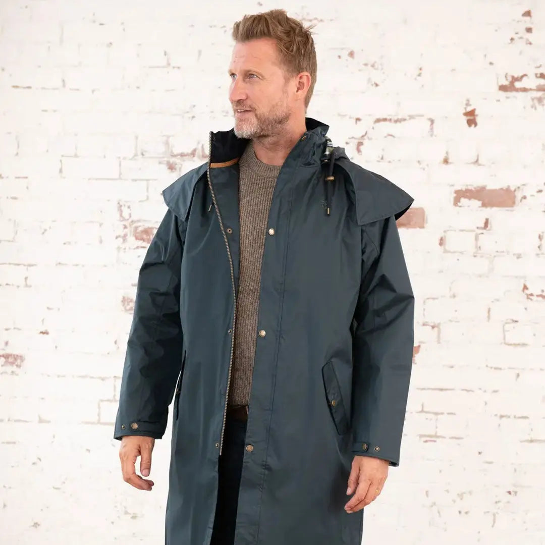 Long teal raincoat from Lighthouse Stockman, perfect for a cold winter’s day