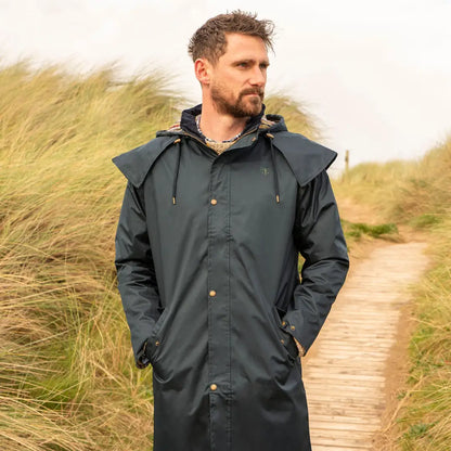Man wearing a Dark Green Lighthouse Stockman Full Length Waterproof Rain Coat with a hood