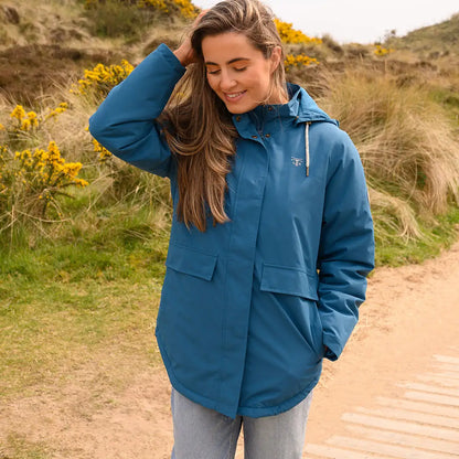 Woman in teal Lighthouse Tess Ladies Coat, perfect for country clothing and outdoor activities