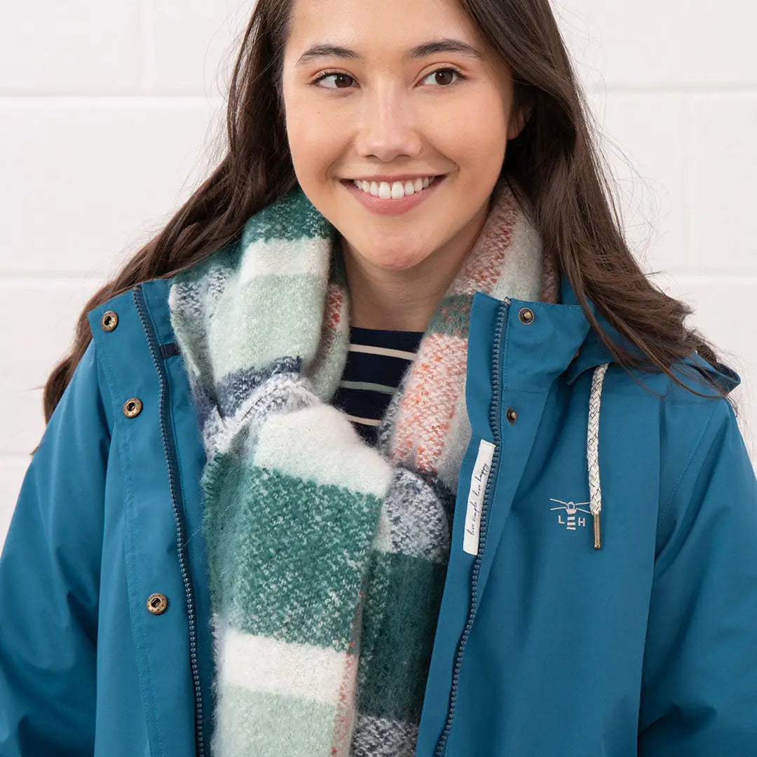Woman in teal Lighthouse Tess Ladies Coat with plaid scarf, perfect country outdoor clothing