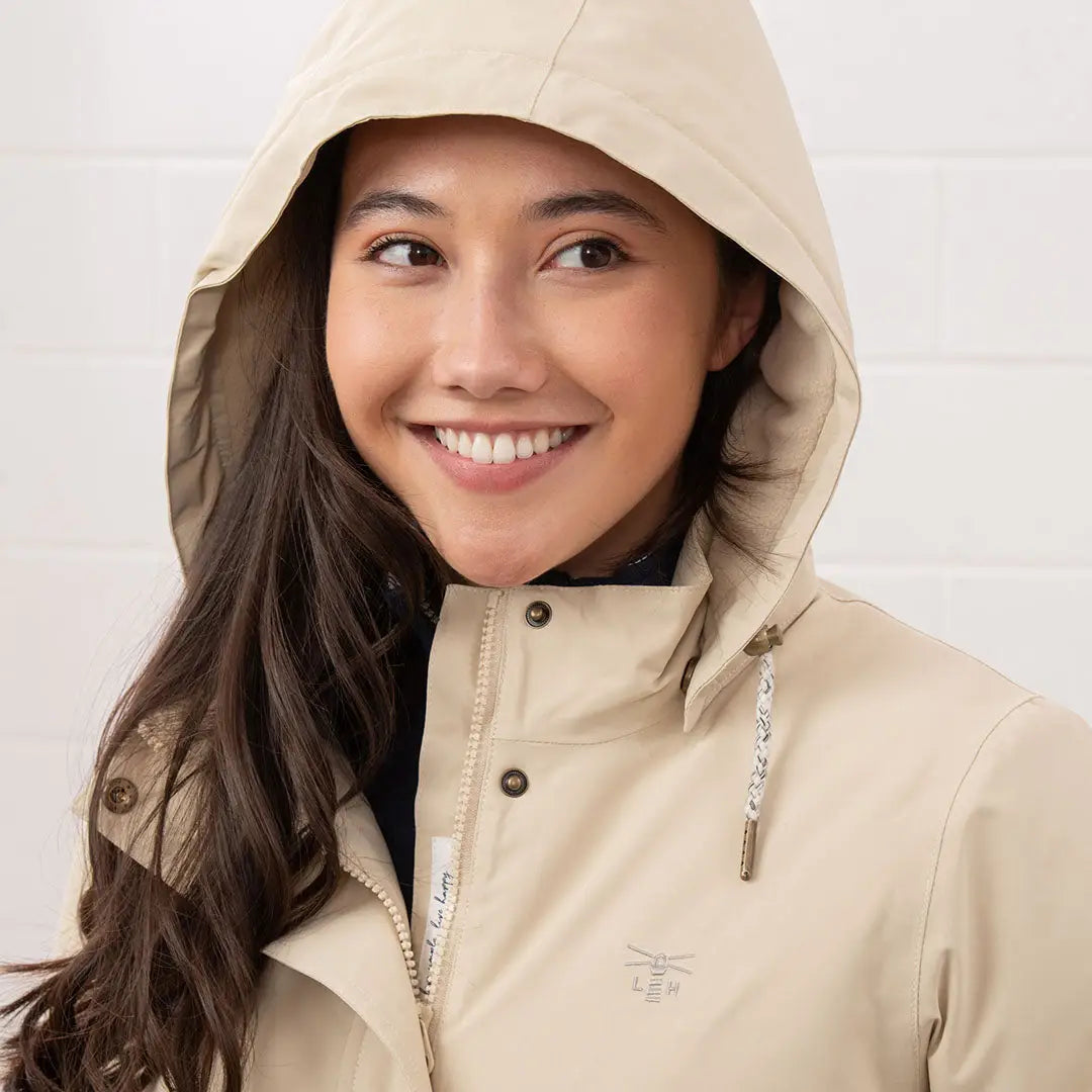 Smiling woman in beige Lighthouse Tess Ladies Coat, perfect country clothing for outdoors