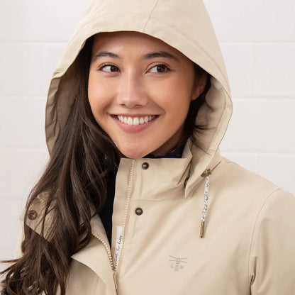 Smiling woman in beige Lighthouse Tess Ladies Coat, perfect country clothing for outdoors
