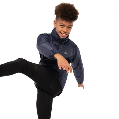 Smiling kid in a navy Mac in a Sac Origin 2 Kids Jacket with fully taped seams