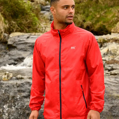 Bright red Mac in a Sac Origin 2 waterproof jacket worn by an adult outdoors