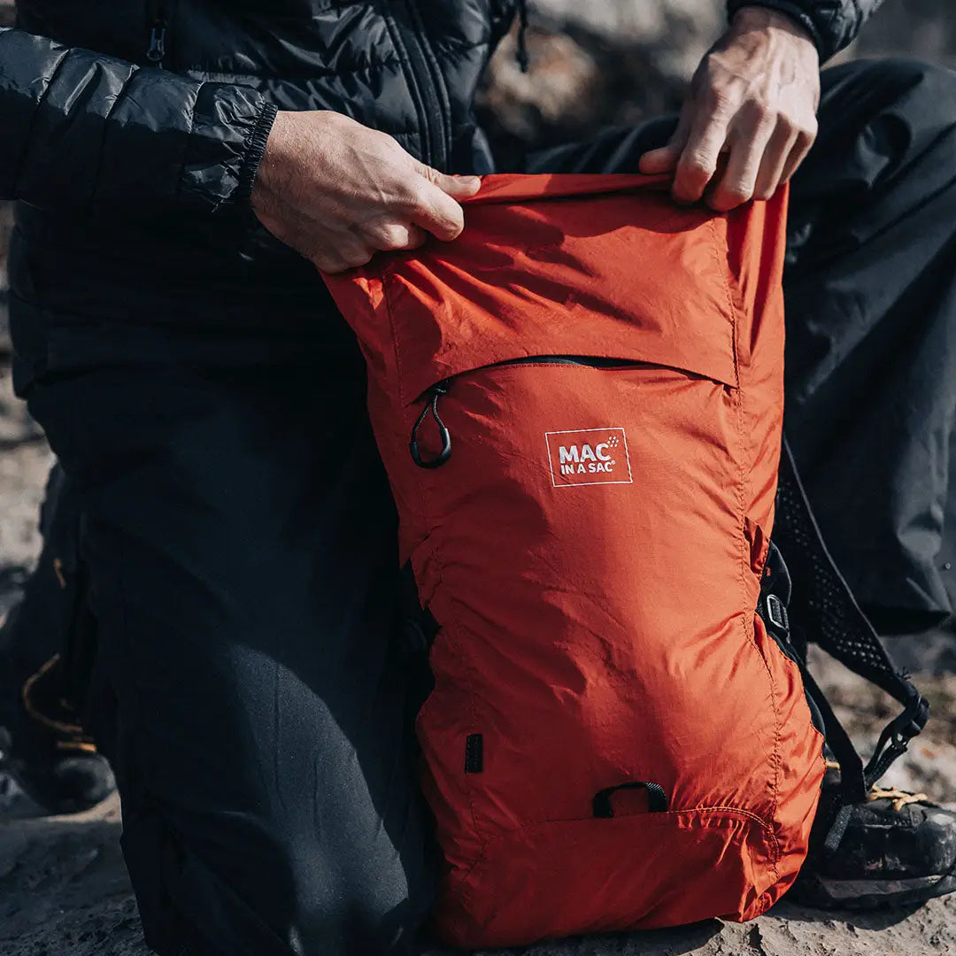Orange lightweight Mac in a Sac Travelite Backpack perfect for adventures or everyday use