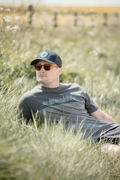 Man in sunglasses and cap lying on grass in New Forest 2-Tone Graphic T-Shirt forest clothing graphic
