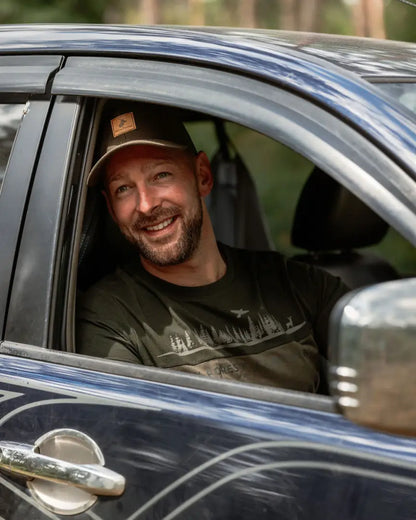 Smiling man in a car wearing New Forest 2-Tone Graphic T-Shirt forest clothing graphic