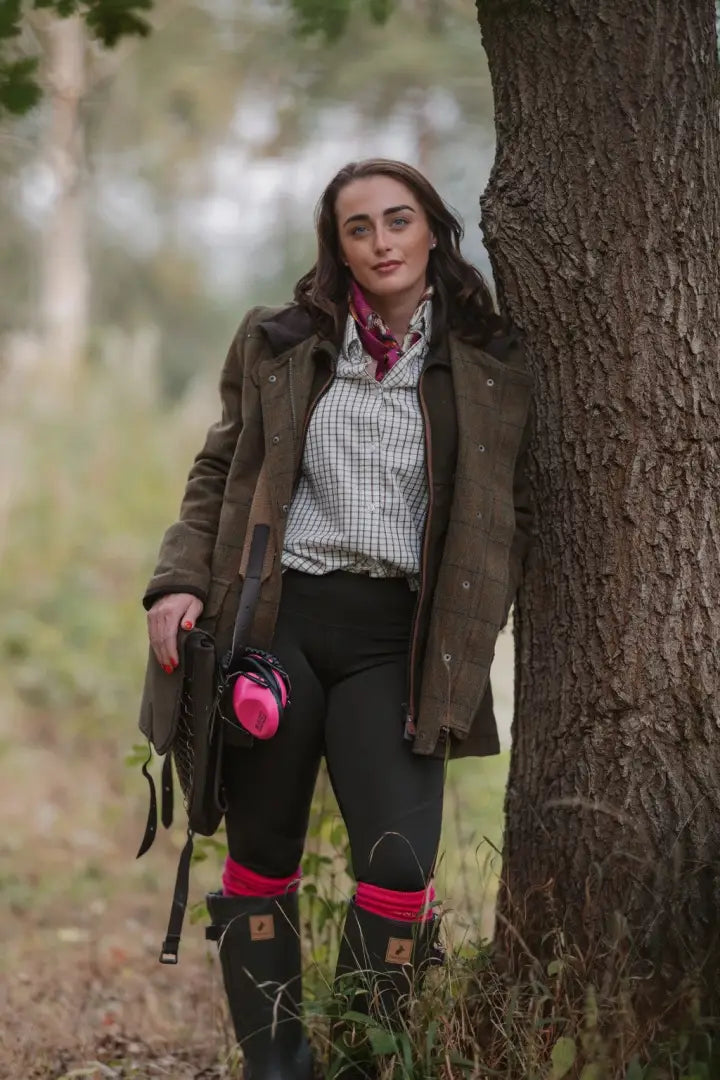 Woman in hunting gear with rifle wearing New Forest Avon Zip Wellington Boots outdoors