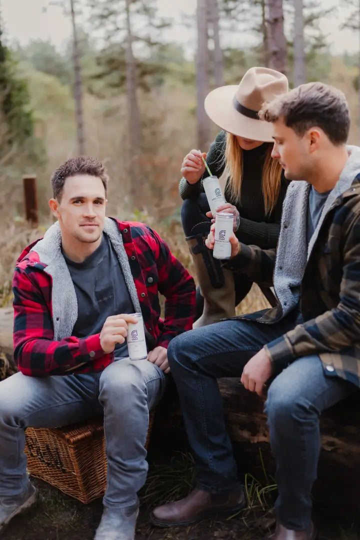 Three friends enjoying drinks in cozy Forest Canadian Sherpa Shirts