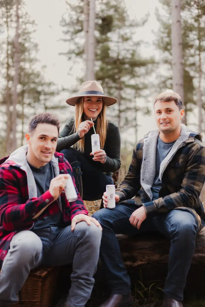 Three friends enjoying drinks in a stylish green lumberjack shirt, the Forest Canadian Sherpa