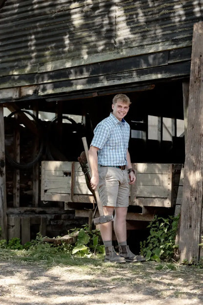 Smiling man with garden tool wearing New Forest Chino Shorts in forest chino style
