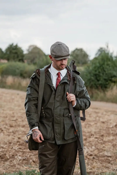 Man in green hunting jacket and tie wearing New Forest Country Sport Trousers