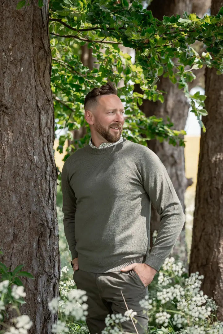 Man wearing New Forest Crew Neck Jumper in olive green, perfect for a forest crew look