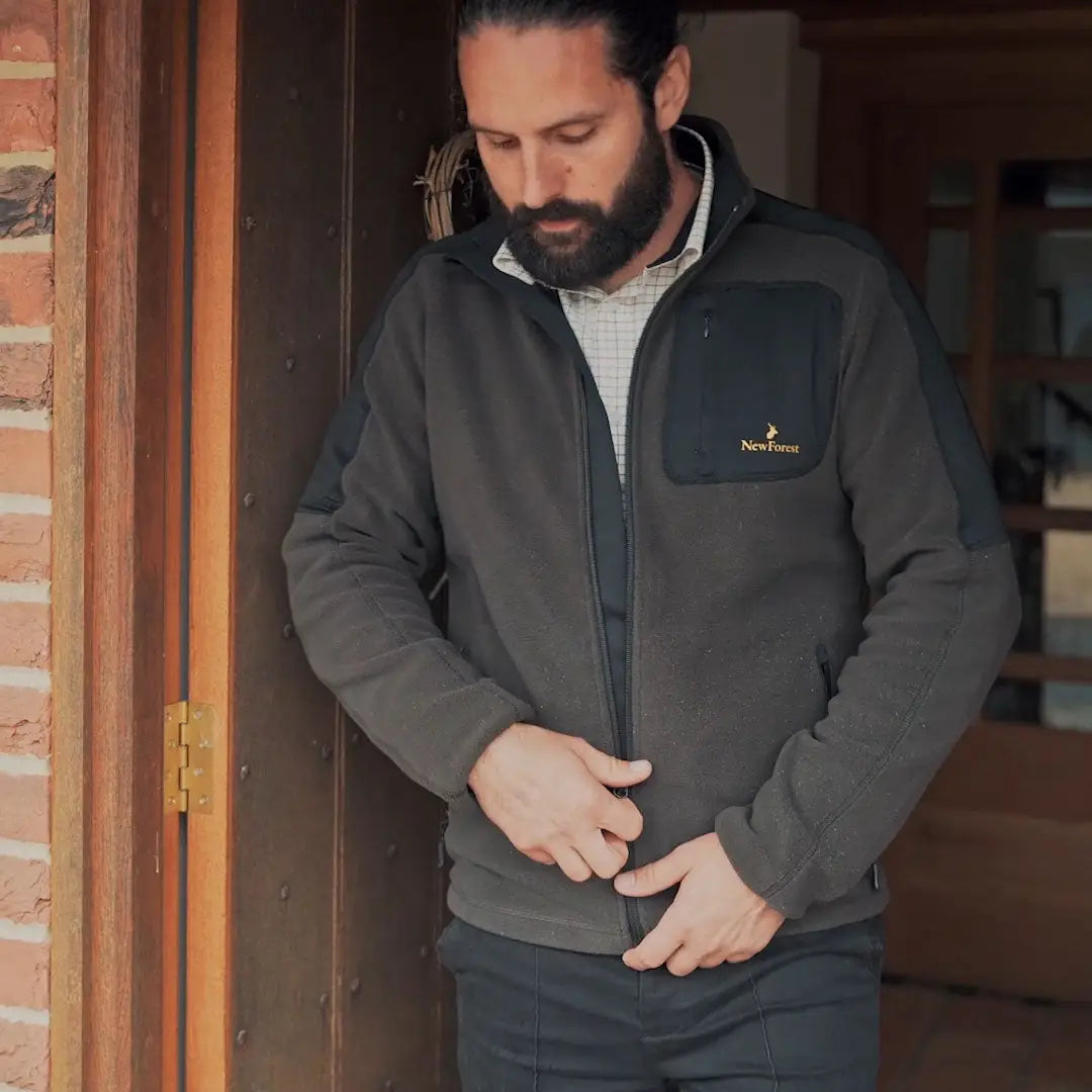Man zipping up forest fallow fleece jacket from New Forest Fallow collection