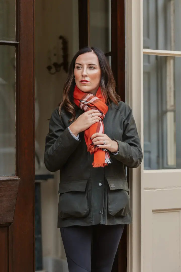 Woman in forest freya ladies wax jacket with festive orange plaid scarf