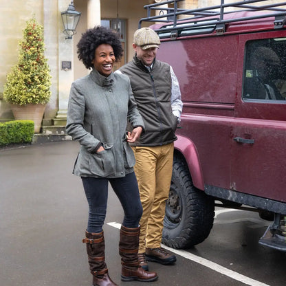 Maroon Land Rover SUV with roof rack showcasing the Forest Grouse Padded Gilet for added warmth