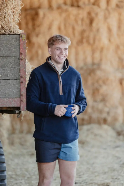 Smiling man in Navy Quarter-Zip and New Forest Harlequin Rugby Shorts, great for country clothing and hunting style