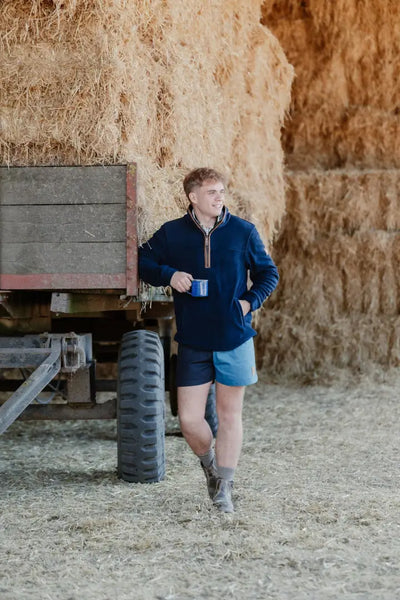Man in navy rugby shorts and shorts showing New Forest Harlequin Country Clothing