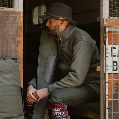Man in hat and olive jacket showcasing New Forest Hawker Waterproof Fleece Jacket