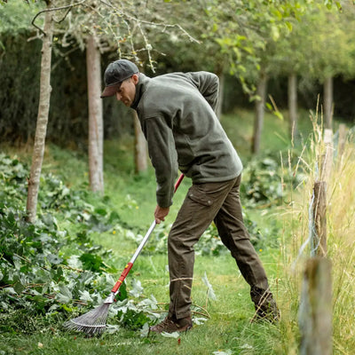 Man using a weed trimmer in a New Forest Hawker classic country fleece jacket