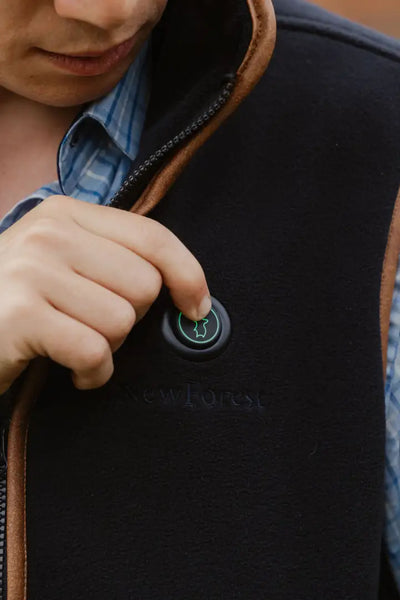 Black heated vest featuring a power button from the New Forest Heated Fleece Gilet