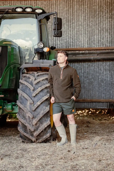 Man in outdoor clothing wearing the New Forest Knightwood Quarter Zip Fleece