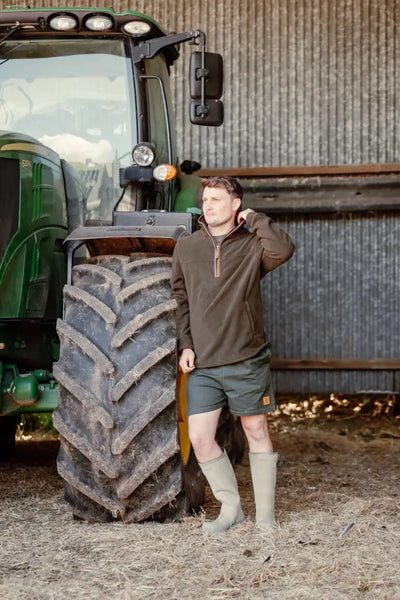 Man in outdoor clothing wearing the New Forest Knightwood Quarter Zip Fleece