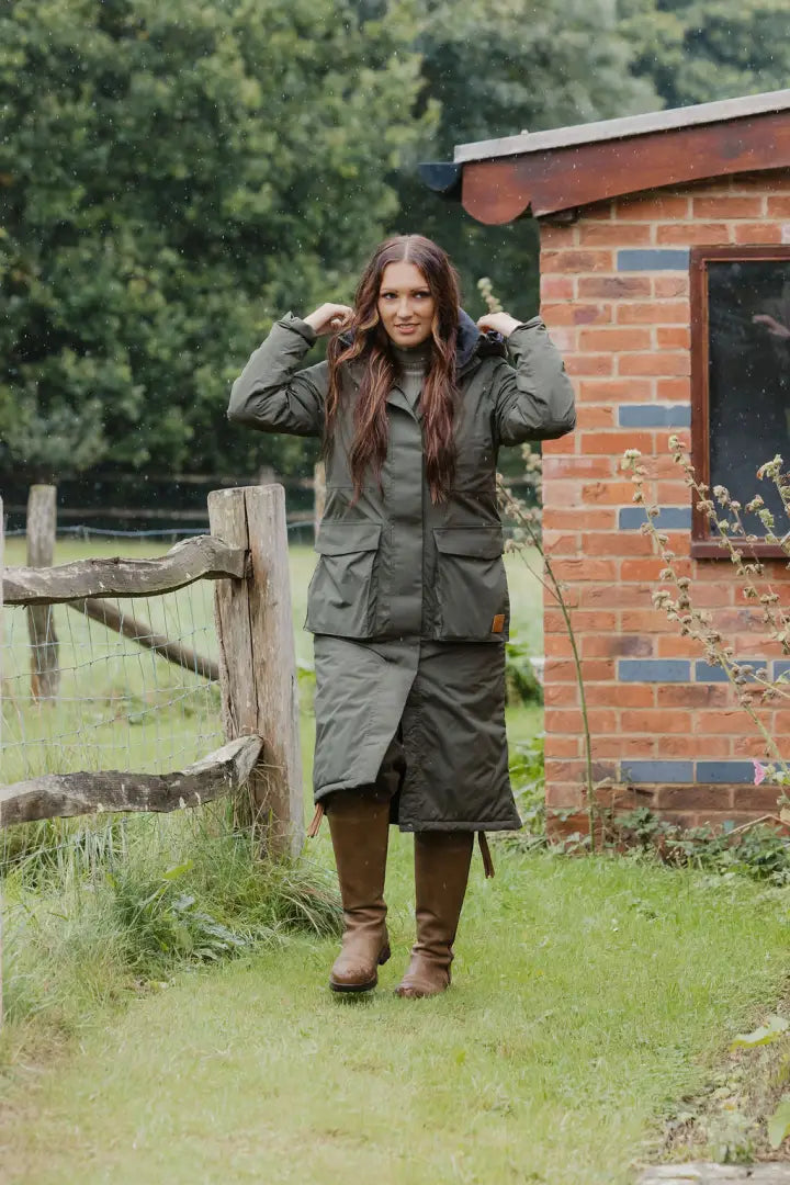 Woman in olive green quilted coat and skirt wearing a Forest Ladies Arctic Parka