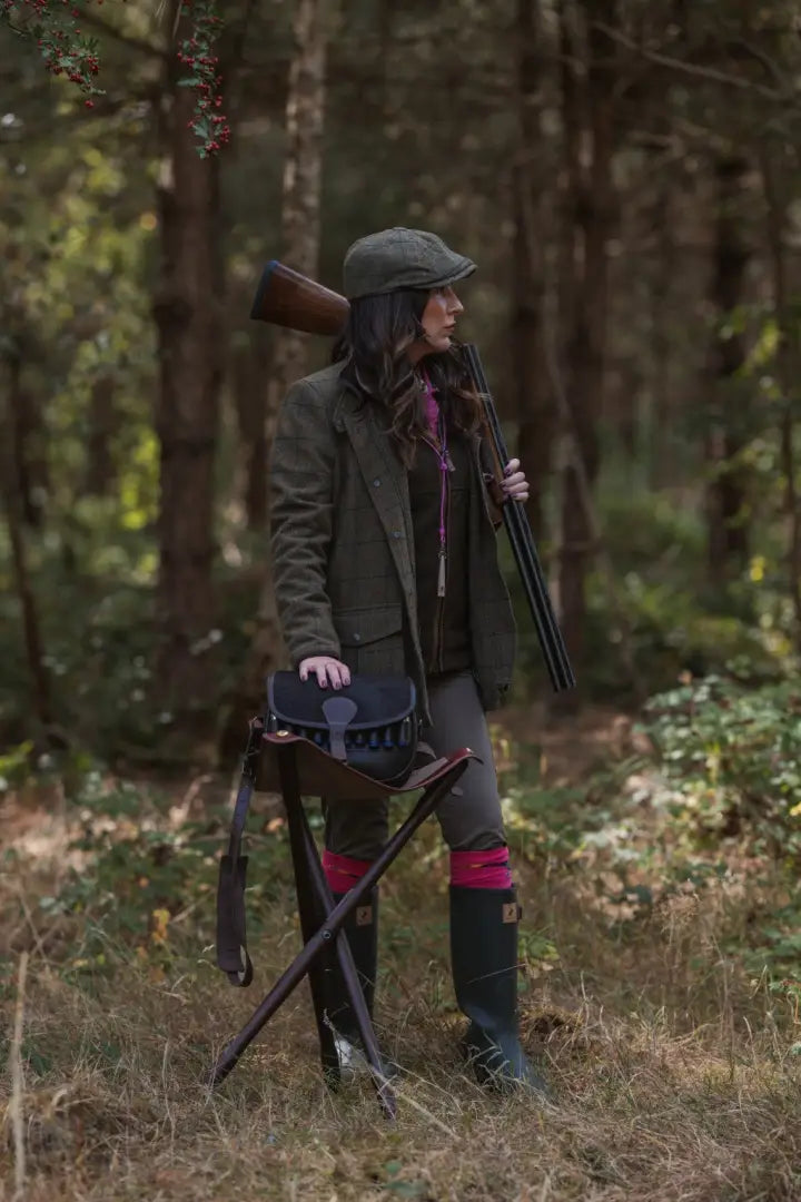 Woman in hunting attire with shotgun and stick wearing New Forest Ladies Baker Boy Hat