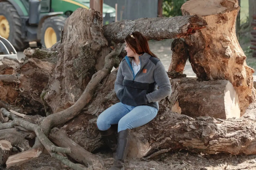 Woman sitting on a tree stump in New Forest Ladies Fox Fibre Pile Fleece, cozy fibre pile fleece