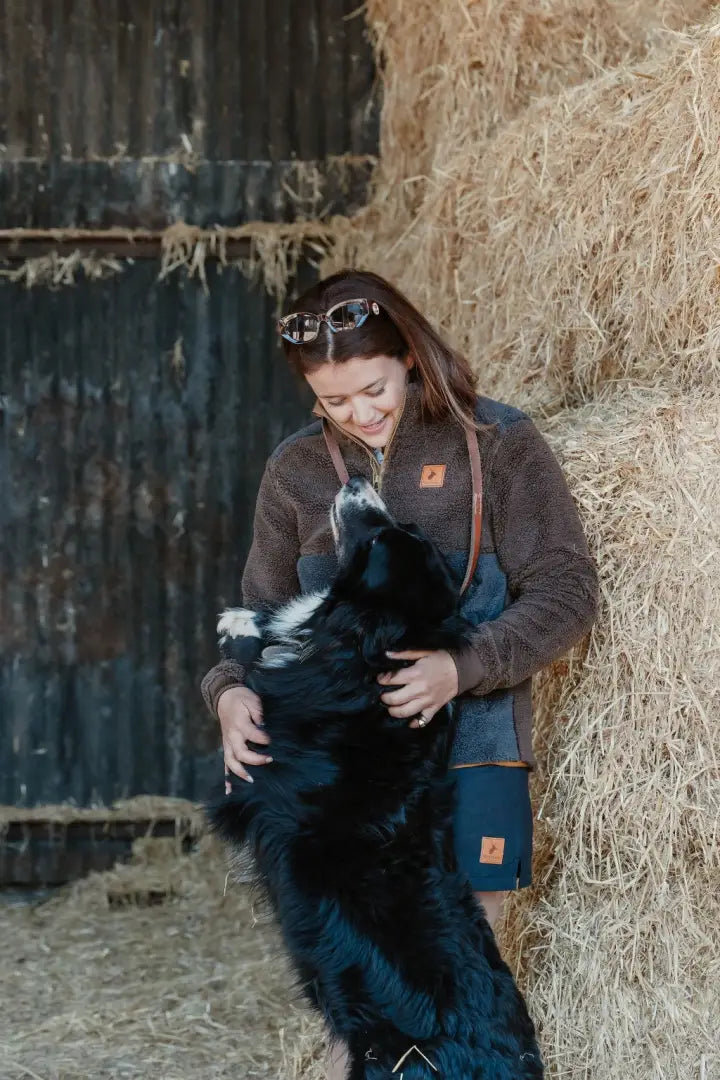 Woman hugging a black and white dog in New Forest Ladies Fox Fibre Pile Fleece