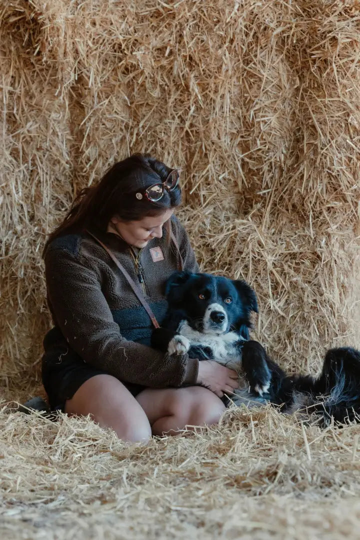 Woman cuddling dog in hay wearing New Forest Ladies Fox Fibre Pile Fleece