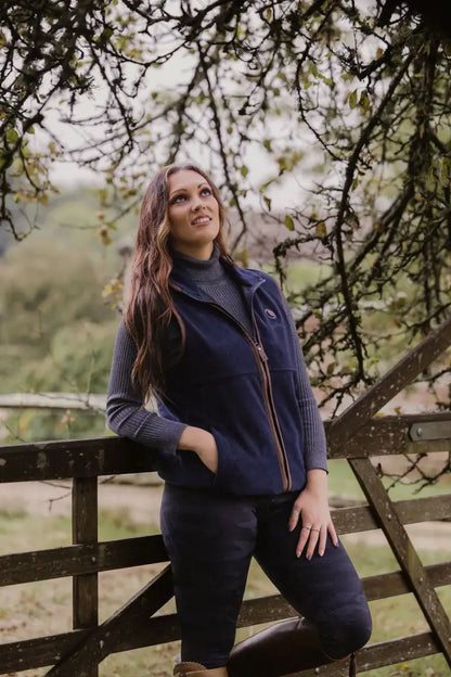 Woman in navy fleece vest showcasing New Forest Ladies Heated Fleece Gilet