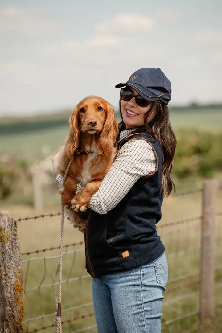 Woman holding a Cocker Spaniel in New Forest Ladies Knightwood Gilet for outdoor country hunting attire